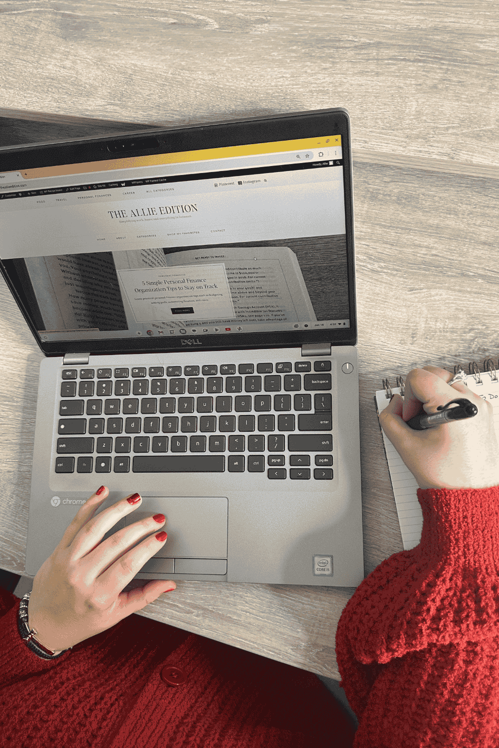 Girl working on laptop and writing in notebook