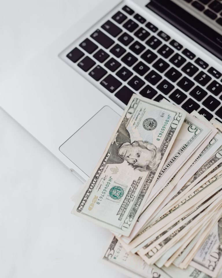 laptop with money on top, how to increase sources of income